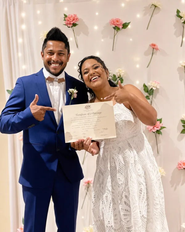 Samadhi and Shiran, smiling and showing their rings after their marriage registration.
